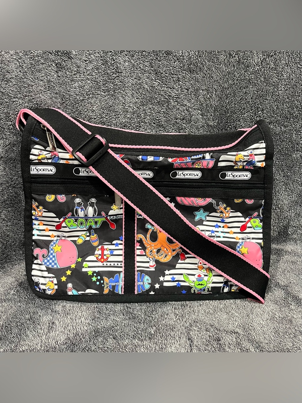 LeSportsac Deluxe crossbody bag featuring a vibrant nautical-theme